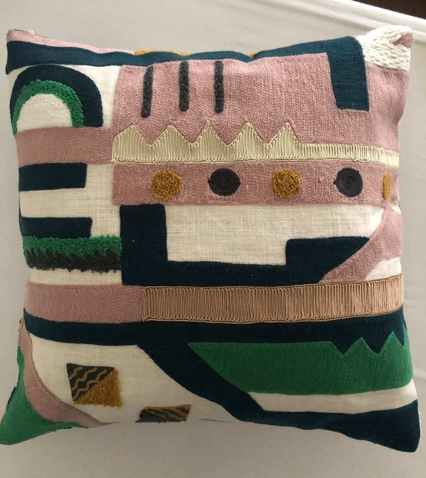 Filled cushion with graphic embroidery