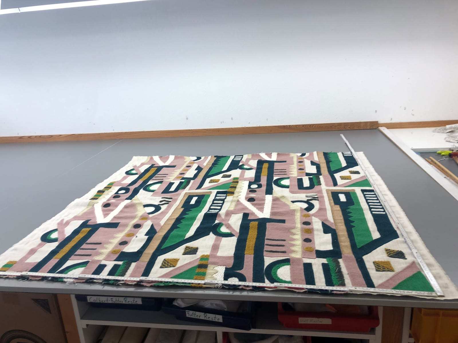 Embroidered fabric on the workshop cutting table